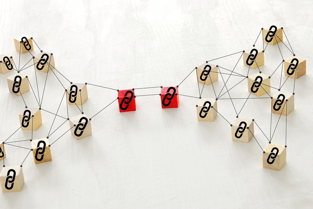 Conceptual illustration of backlinks network using wooden blocks and link icons, showing interlinked SEO connections and web authority